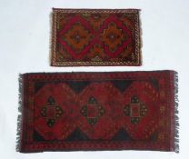 AFGHAN KHAN HAND-WOVEN PURE WOOL RUG, crimson and black with a row of three quatrefoil medallions,