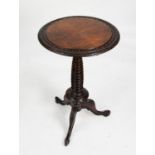 NINETEENTH CENTURY CONTINENTAL FIGURED AND CARVED WALNUT TRIPOD OCCASIONAL TABLE, the circular,