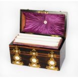 VICTORIAN AMBOYNA AND BRASS MOUNTED DOME TOP STATIONERY BOX, with fancy, studded strap work panels