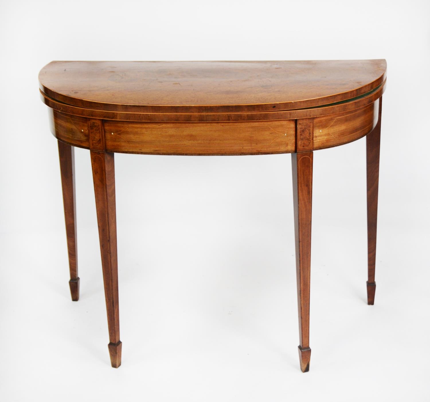 GEORGE III LINE INLAID AND FIGURED MAHOGANY CARD TABLE, the fold over D shaped top with central