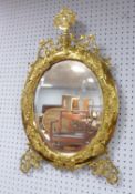 NAPOLEON III BRASS FRAMED WALL MIRROR, the oval, bevel edged plate, within a conforming, moulded