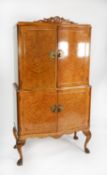 HURWITZ OF LEEDS, GEORGE II STYLE FIGURED AND CAVED WALNUT SERPENTINE FRONTED COCKTAIL CABINET,