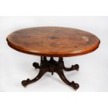 VICTORIAN INLAID AND FIGURED WALNUT LOO TABLE the oval tilt top decorated with foliate scroll inlays