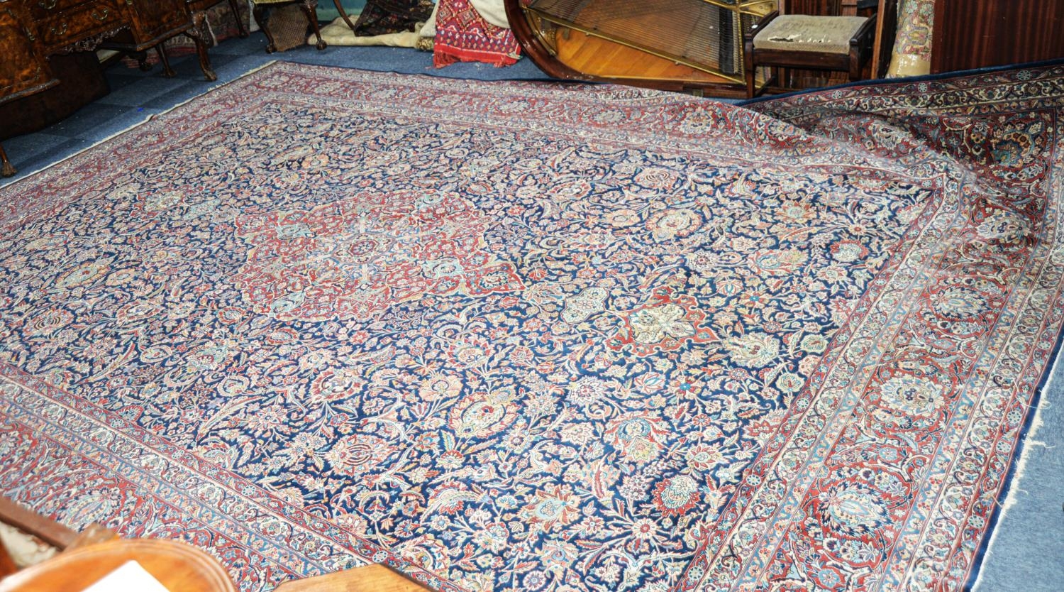 LARGE MID-20th CENTURY KESHAN, PERSIAN CARPET, the lozenge shaped centre medallion red with