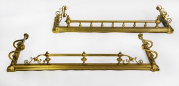 TWO SIMILAR VICTORIAN BRASS FENDERS, each with scroll handles/ rests to the sides, 53” (134.6cm)