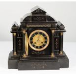 VICTORIAN BLACK SLATE AND GILT METAL MOUNTED MANTLE CLOCK, the 4 ¼” Roman dial with matted gilt