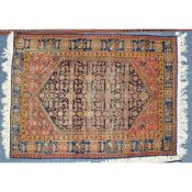 SEMI-ANTIQUE EASTERN RUG with large black hexagonal field, the pointed ends with zigzag edges, red