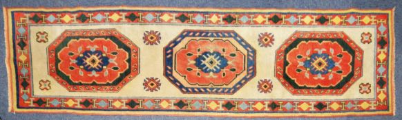 EASTERN RUNNER with three large octagonal medallions in red and blue, on an off-white field
