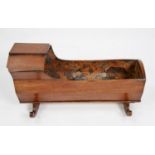 VICTORIAN MAHOGANY DOLL’S CRADLE, with canopy top and chamfered sides, floral paper lined