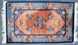 EASTERN RUG with pale and dark blue open work circular centre floral medallion and spandrels, on a