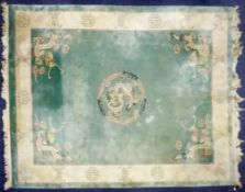 HEAVY QUALITY EMBOSSED WASHED CHINESE CARPET, with plain pale green field, with centre circular
