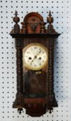 EARLY TWENTIETH CENTURY DARK STAINED PINE CASED VIENNA STYLE SMALL WALL CLOCK, with 4 ½” silvered