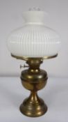 BRASS OIL TABLE LAMP, with fluted opaque white glass shade and clear chimney, 19 ¾” (50.2cm) high