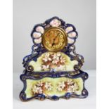 VICTORIAN HAND PAINTED POTTERY MANTLE CLOCK, the 6” Roman brass dial with engine turned centre,