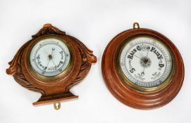 TWO EARLY TWENTIETH CENTURY OAK CASED ANEROID BAROMETERS, one in circular, moulded case, 10 ¾” (27.