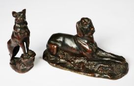 TWO PATINATED BRONZE MODELS OF DOGS, one as a RECLINING LURCHER, 3 ½” (8.9cm) high, 6 ¼” (15.9cm)