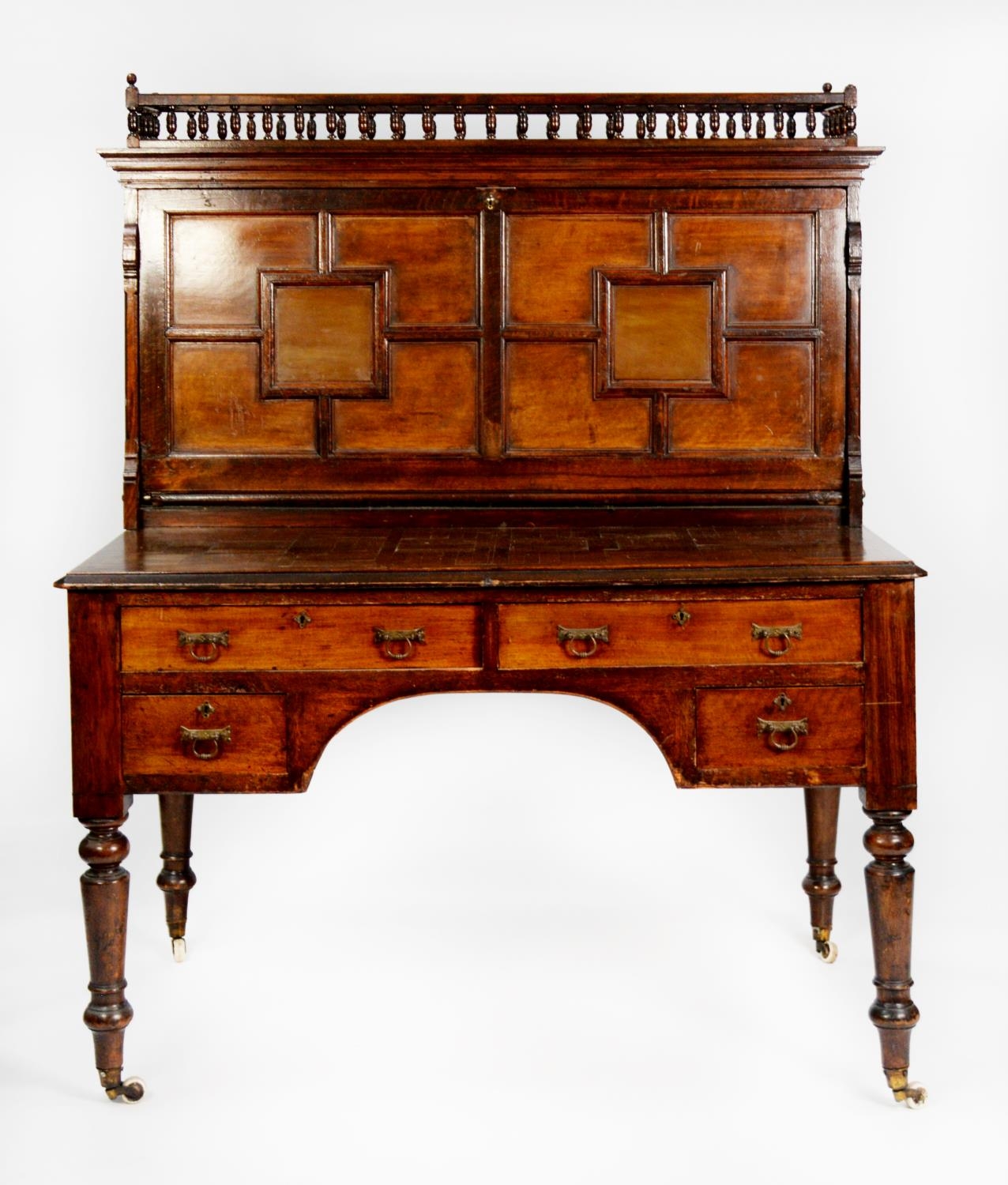 VICTORIAN AESTHETICS MOVEMENT OAK AND WALNUT CLERKS DESK, the galleried oblong top above a large,