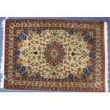 KIRMAN, PERSIAN RUG with shaped circular crimson medallion on an ivory field with scattered formal