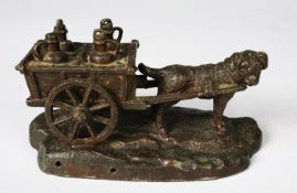 PATINATED SPELTER GROUP OF A DOG PULLING A CART CONTAINING FOUR MILK CHURNS, 3 ¼” (8.2cm) high,