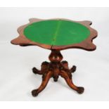 VICTORIAN FIGURED AND CARVED WALNUT PEDESTAL CARD TABLE, the fold-over top of serpentine outline