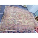 KIRMAN, PERSIAN CARPET with large openwork petal shaped floral and foliate scroll medallion