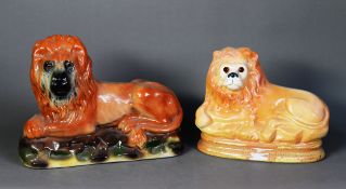 NINETEENTH CENTURY POTTERY MODEL OF A RECUMBENT LION, with glass eyes, 8 ¾” (22.2cm) high,