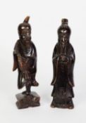 TWO CHINESE BLACK PATINATED CARVED SOFTWOOD FIGURES OF DEITIES, 11 3/4" and 12" high (29.5cm and