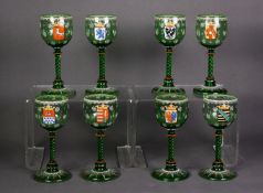 SET OF EIGHT GERMAN ENAMELLED AND CRESTED GREEN GLASS TALL STEMMED GLASSES, each with spiral