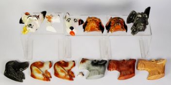 THIRTEEN TWENTIETH CENTURY MOULDED POTTERY DOG MASK WALL PLAQUES, some duplicates, 5 ½” (14cm) and