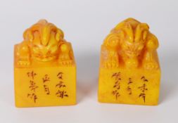 PAIR OF CHINESE YELLOW SOAPSTONE SEALS, the top handle of each carved as an Oni, one with head