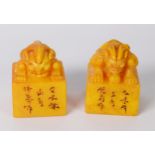 PAIR OF CHINESE YELLOW SOAPSTONE SEALS, the top handle of each carved as an Oni, one with head