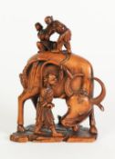 WELL CARVED CHINESE BLONDE WOOD GROUP, modelled as a man driving an oxen with two children