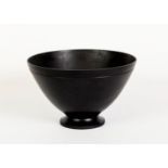 KEITH MURRAY FOR WEDGWOOD, BLACK BASALT POTTERY BOWL, of flared, footed form with indented border