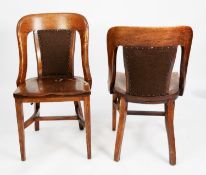 SET OF FIVE EARLY TWENTIETH CENTURY HEAVY OAK LIBRARY OR BOARDROOM CHAIRS, each with central pad,