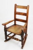 NINETEENTH CENTURY CHILD’S ELM AND FRUITWOOD LADDER BACK ROCKING CHAIR, of typical form with