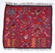 EASTERM KELIM FLAT WEAVE PANEL with a pattern of birds in flight, on a crimson background, 3ft2in