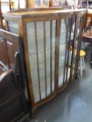 A PRE-WAR DOUBLE DOOR DISPLAY CABINET, HAVING TWO GLASS SHELVES, RAISED ON CLAW AND BALL FEET