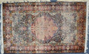 SEMI-ANTIQUE PERSIAN FINELY KNOTTED PART-SILK RUG with circular scolloped edge, red centre medallion