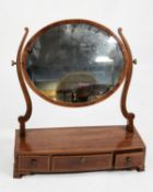 GEORGE III LINE INLAID MAHOGANY TOILET MIRROR, the oval plate in a crossbanded frame, flanked by