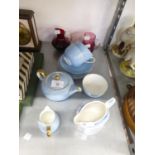 CRANBERRY GLASS CREAM JUG; A RUBY GLASS CREAM JUG; WEDGWOOD CHINA PALE BLUE TEA FOR TWO TEA SET OF 9