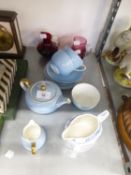 CRANBERRY GLASS CREAM JUG; A RUBY GLASS CREAM JUG; WEDGWOOD CHINA PALE BLUE TEA FOR TWO TEA SET OF 9