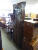 A GOOD QUALITY REPRODUCTION OAK FLOOR STANDING CORNER CUPBOARD