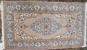 KASHMIRI HAND-MADE KIRMAN STYLE RUG with pale blue and ivory stripped lozenge shaped centre