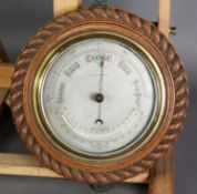 OAK FRAMED COMBINATION ANEROID BAROMETER AND THERMOMETER, the silvered dial reading from 28-31,