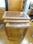 A NEST OF THREE TILE TOPPED TEA FRAMED COFFEE TABLES