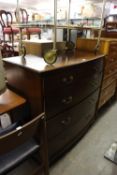 AN EDWARDIAN MAHOGANY SHALLOW BOW-FRONTED CHEST OF TWO SHORT AND THREE LONG DRAWERS, WITH BRASS