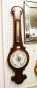 AN EARLY TWENTIETH CENTURY WALNUT BANJO BAROMETER AND THERMOMETER, WITH SCROLL OUTLINE