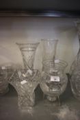 AN URN SHAPED CUT GLASS VASE ON SQUARE PLINTH BASE (AS FOUND); A CUT GLASS TRUMPET FLOWER VASE AND