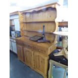 A MODERN PINE WELSH DRESSER WITH RAISED PLATE RACK, THREE DRAWERS OVER THREE DOORS, 4’8” WIDE