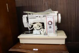 A NEW HOME 'TRIPLE ZIG ZAG' MODEL No. 888 ELECTRIC SEWING MACHINE, IN HARD PLASTIC CASE